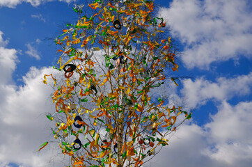 Wall Mural - Beautiful colorful decor for Easter. Traditional Easter painted eggs and ribbons on a birch tree in Easter decor at the spring fair in Prague, Czech Republic. Selective focus.