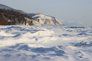 Wall Mural - Lake Baikal. Snow-covered ice. Northern coast of Lake Baikal in the vicinity of Severobaikalsk. Republic of Buryatia, Russia. Beautiful winter landscape. Cold weather. Nature of Siberia.