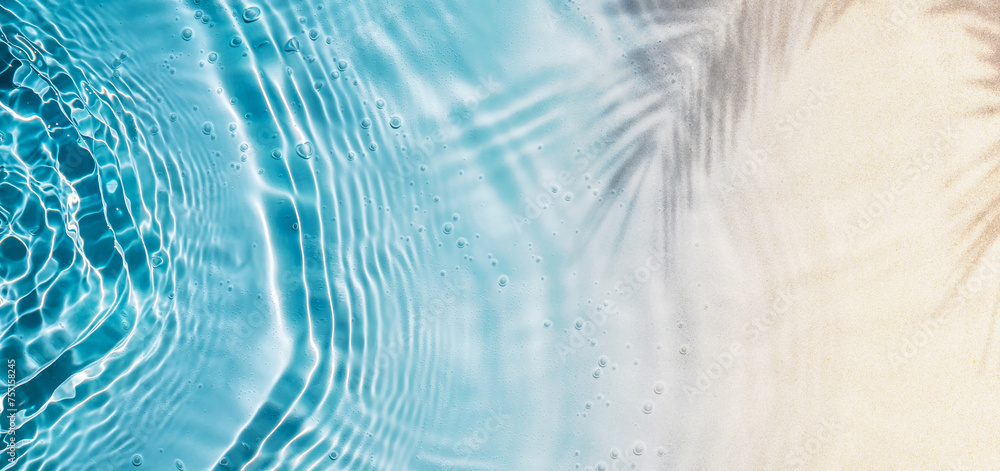 abstract sand beach with palm leaf shadow and blue water wave from above, summer vacation outdoors in tropical paradise nature, background with space 