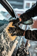 © Image forest - Close-Up of Hand Washing Car Window with Sponge
