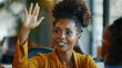 Portrait of a black afro american business woman rising hand to ask a question during a meeting , the powerful businesswoman is not afraid to take speak in public in front of her coworkers