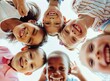 © Svetlana - photo of happy multiethnic children huddled together. Group of cute happy kids huddling, looking down at camera and smiling