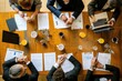 A diverse group of individuals sitting together around a large wooden table engaged in a lively discussion, Overhead view of a professional meeting with documents and coffee cups, AI Generated