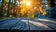 Banner with empty old wooden table. Blurred background with blooming flowers and trees in the forest, with orange un rays.