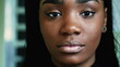 © Marco - Macro close-up portrait of a serious young black woman looking directly at camera with solemn expression. South American hispanic adult girl in 20s of African descent