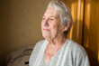 © Connect Images - Elderly woman lost in thought by a window