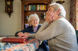 © Connect Images - Two elderly women sharing a joyful moment together at home