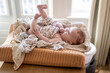 © Connect Images - Baby lying comfortably on a woven basket at home