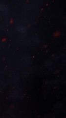 Wall Mural - vertical fire sparks against blue smoke 4k loop features a dark blue background with orange and red 