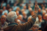 Fototapeta  - senior man with hand up to talk at local town hall meeting, from back view