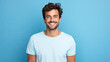 ©  Mohammad Xte - Handsome young man smiling while standing against blue background