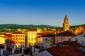 Wall Mural - amazing evening town with church, tower with bell , yellow houses and beautiful hills with nice cloudy sky on background, european cityscape of Italy