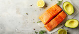Fototapeta Tulipany - Fresh raw salmon fish and sliced avocado top view. Healthy fats, mediterranean diet. Food and health theme.