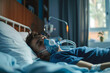 A young man wearing an oxygen mask, sleeping in a bed, recovering from an illness
