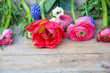 Fototapeta Kwiaty - pink tulips on wooden background - bouquet of spring flowers - season greeting card