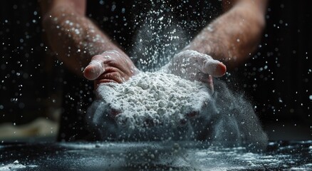 Chef's hands dynamically dusting flour in a dark