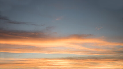 Wall Mural - sunset scenery with yellow and orange lighted cloud bands and blue gray above