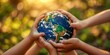 © YuDwi Studio - Several individuals holding the planet Earth in their hands, emphasizing global unity and responsibility.