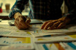 © Mongkol - A person is writing on a piece of paper with a pen. The paper is covered in various graphs and charts
