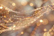 A web of gold and silver threads with a blurry background. The image has a dreamy, ethereal quality to it