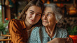 © MP Studio - Young woman and an elderly woman closely posing together, smiling warmly, giving a sense of family, affection, and generational connection.