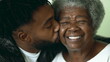 Adult grandson kissing elderly African American grandmother on the cheek in tender affectionate loving moment between two intergenerational family members
