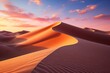 A sand dune in the desert at sunset, under a colorful afterglow sky