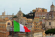 Elevated View of Rome City with various Basilica and Italian Flag flying