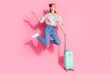 Canvas Print - Full size photo of attractive girl colorful blouse jump hold suitcase palm hold offer look empty space isolated on pink color background