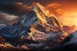 Snowcovered mountain glowing at sunset, with a cloudy sky in the background