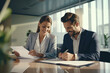 © Aevan - Office contract being signed in an office building by a man and a woman