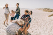 © Marko Geber - Multigenerational family having fun playing football on the beach