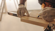 © Jacob Lund - Skilled contractor measuring wood for trim work while renovating a home