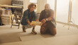 © Jacob Lund - Tiles for a refurbished kitchen: Home improvement team discussing kitchen renovation and flooring upgrade