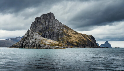 Sticker - Rocky mountain in the water. Blue ocean. Beautiful seascape. Dramatic gray blue sky.