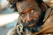 Close up, black african homeless man with beard and broken jacket, poverty slum street life