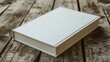 Blank white book on wooden table.