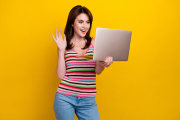 Sticker - Photo of cheerful girl with stylish hairdo wear striped tank waving palm say hi on laptop video call isolated on yellow color background