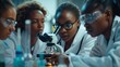 Group of african american scientists working with microscope in laboratory.