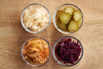 Wall Mural - Selection of fermented foods - kimchi, purple and white sauerkrau and gherkins