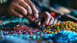 A person sorting colored beads, representing how to organize tasks in business