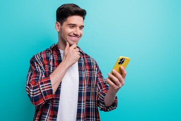 Sticker - Photo of excited clever guy wear checkered shirt reading news modern gadget empty space isolated blue teal color background