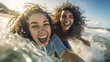 Laughing happy curly teenage girls on a surfboard taking a selfie among the waves in the ocean on a sunny summer day, sporty lifestyle of zoomers,Generated AI 