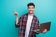 © deagreez - Photo of confident dreamy man dressed plaid shirt typing emails modern gadget showing empty space isolated turquoise blue color background
