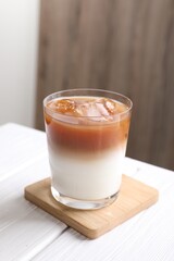 Wall Mural - Glass of iced coffee on white wooden table