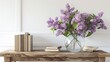 © yusufadi - Beautiful home interior design with bouquet purple lilac flowers in vase with books on wooden table.
