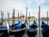 Fototapeta Desenie - Gondolas moored by Saint Mark square with San Giorgio di Maggiore church in Venice, Italy
