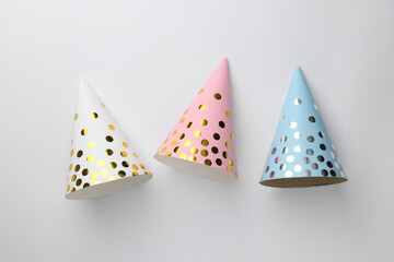 Poster - Colorful party hats on light background, top view