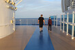 Middle-aged couple in the evening walking on a cruise ship deck