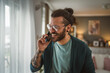 © Miljan Živković - One adult man with eyeglasses stand at home use mobile phone talk
